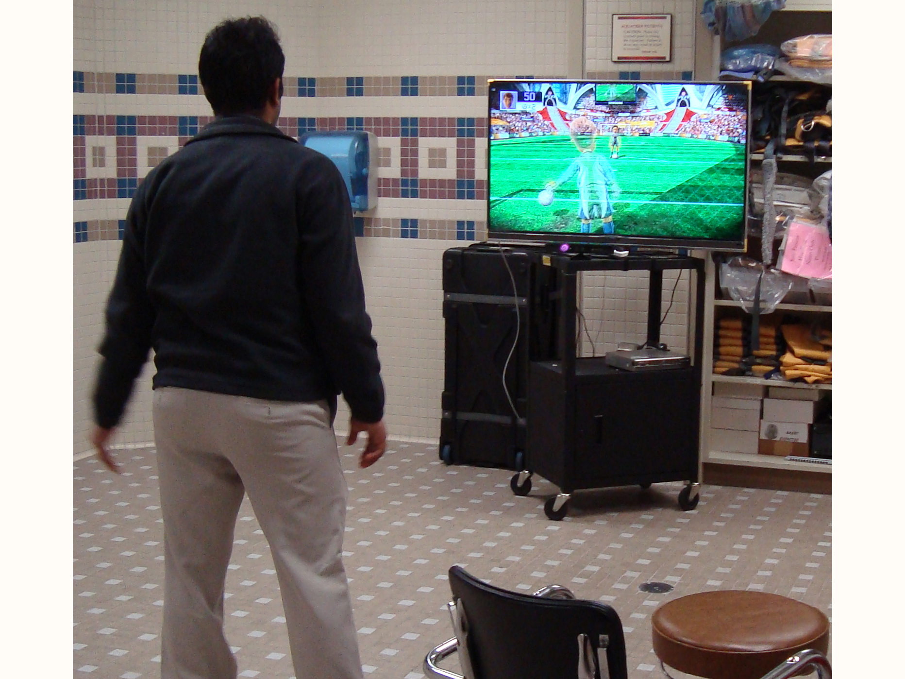 man playing XBox Kinect soccer game